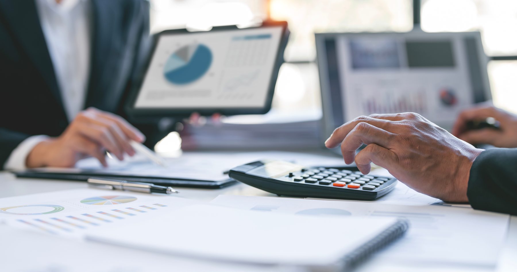 Notebook, calculator and paperwork on a Green Peak Financial desk